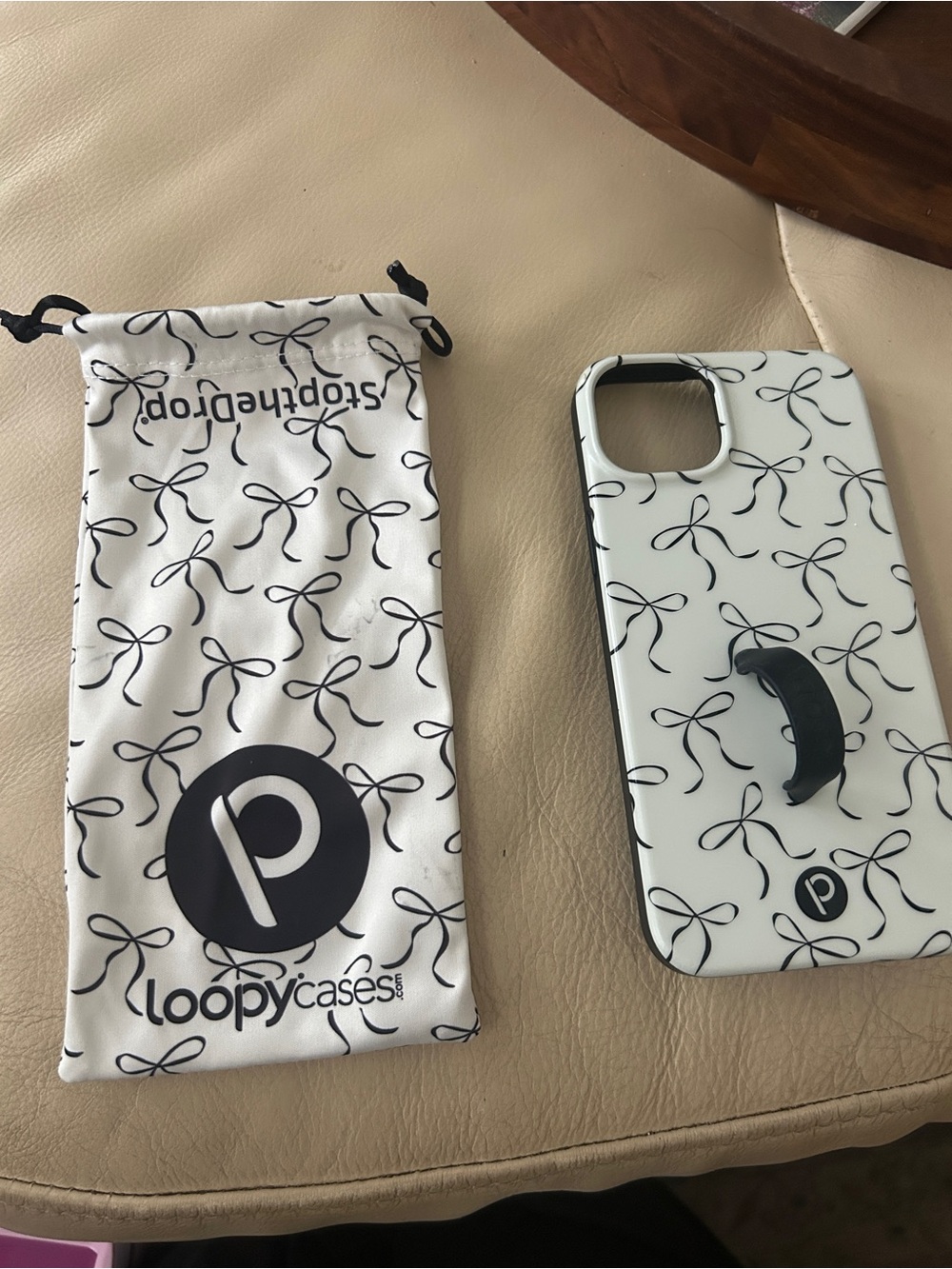Loopy Case White iPhone Case with Black Bow Pattern and Built-in Grip